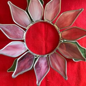 This poinsettia candle ring is hand-crafted and 9” in diameter.